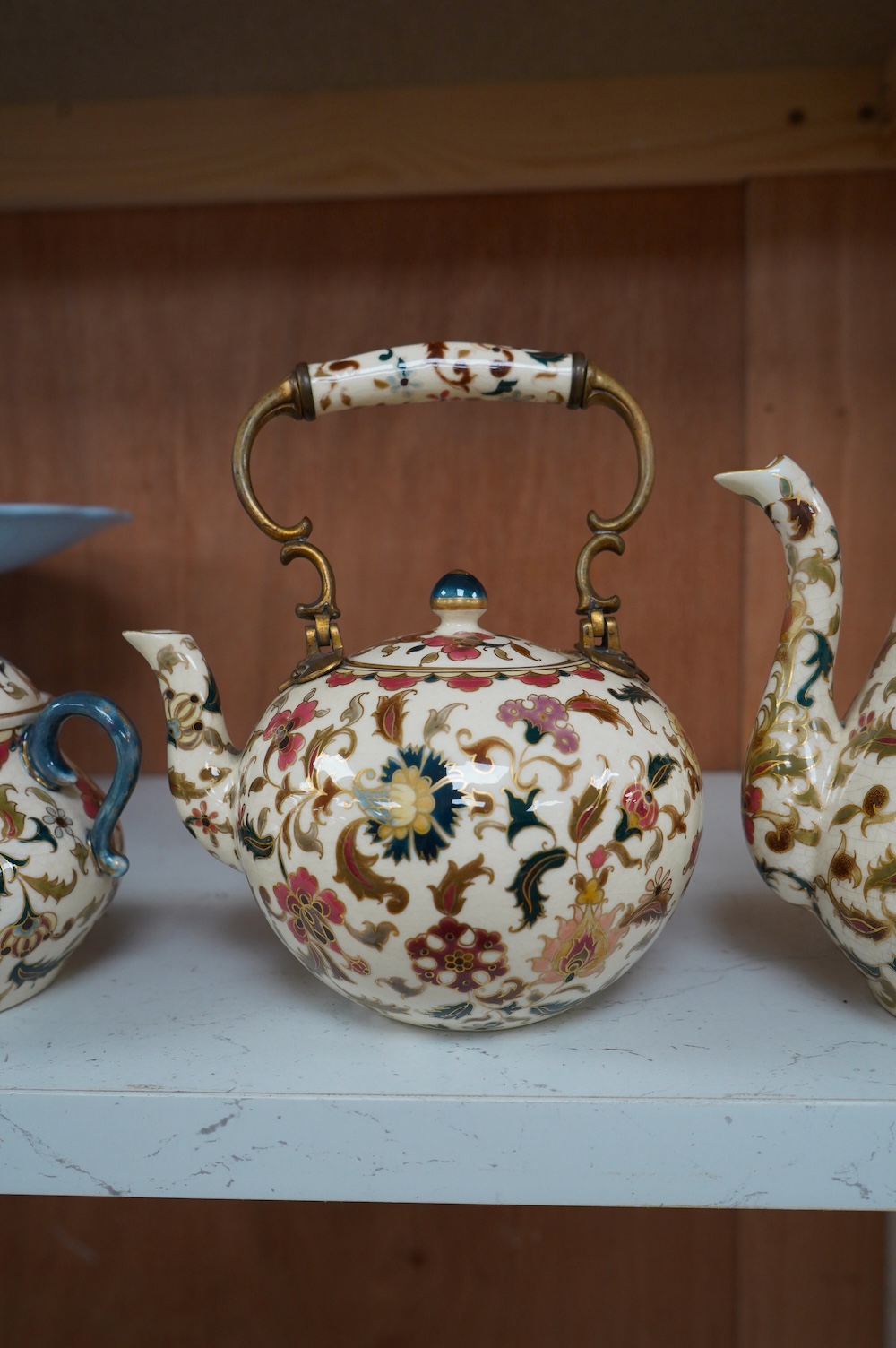 A matched Hungarian Zsolnay floral three piece tea set, largest 17cm high. Condition - fair, crazing throughout